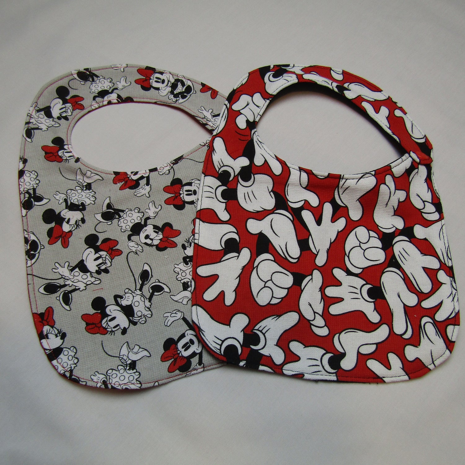 Mickey and Minnie Mouse terry cloth and cotton backed bibs. Snap closure