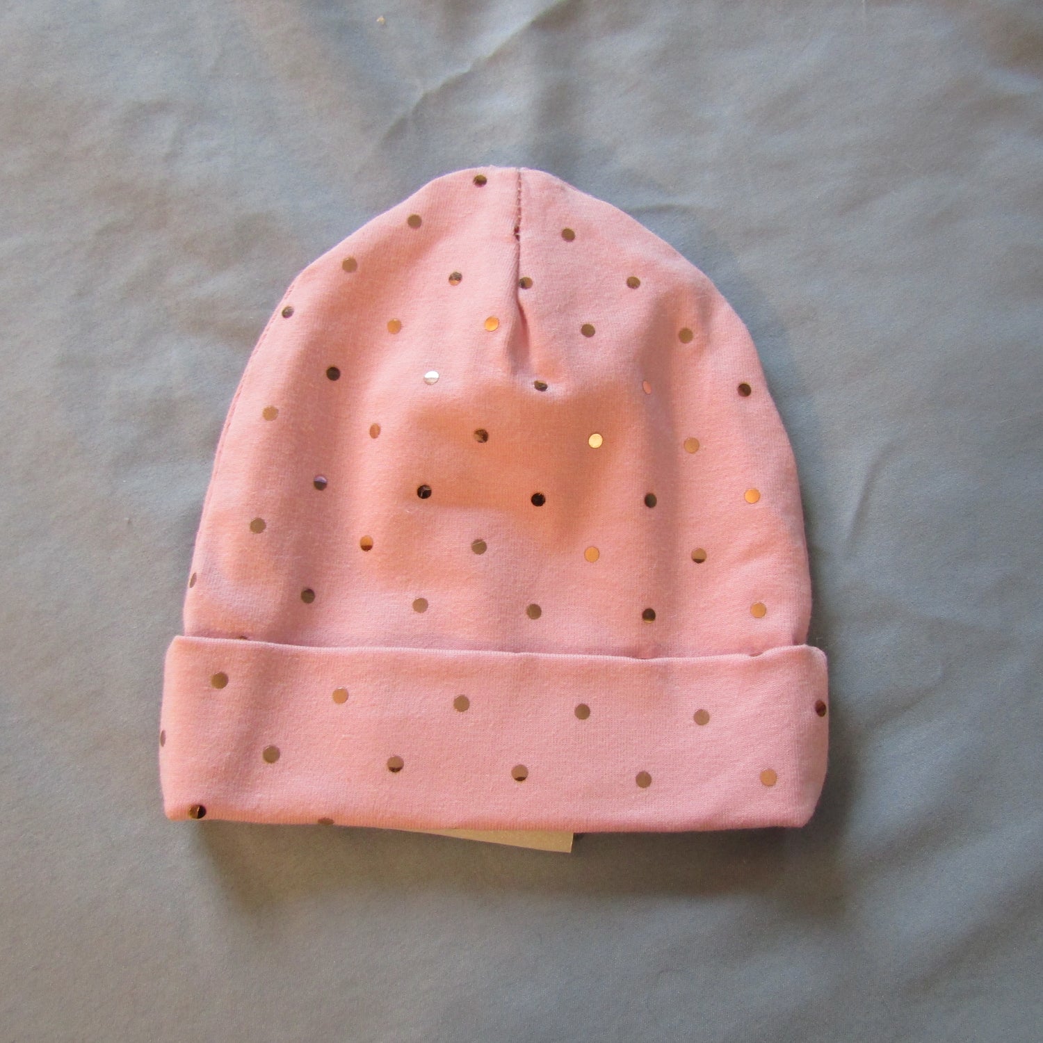 Kids pink stretch knit hat with silver dots. 